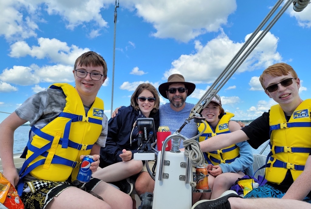 John Carle with Cathy and the kids out on the boat